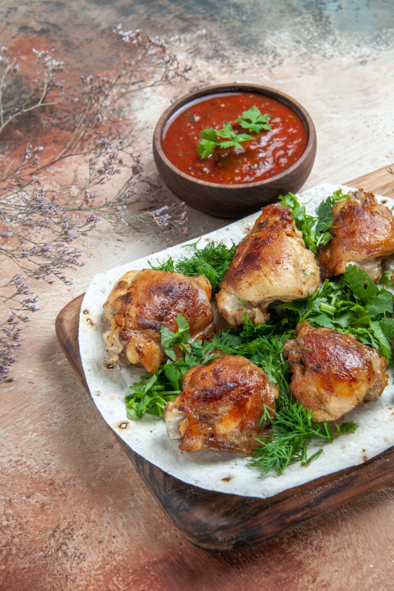 Italian baked chicken leg quarters topped with lemon butter sauce and sun-dried tomatoes
